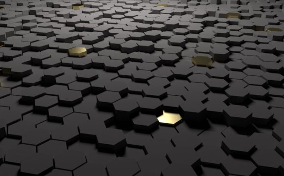Multiple black hexagonal pillars with one in gold