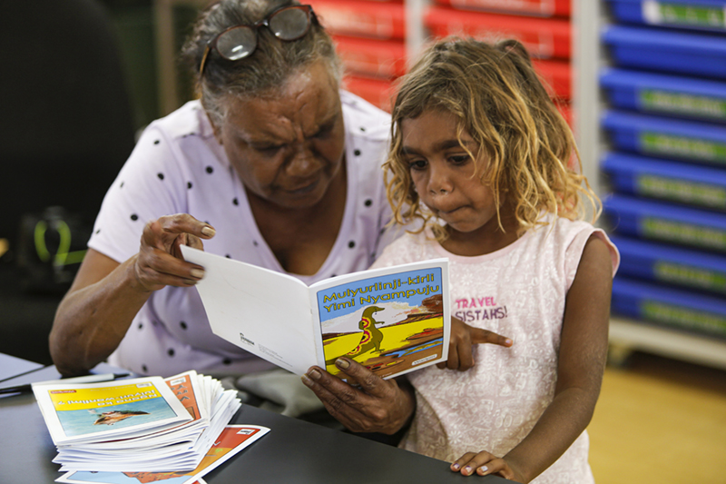 Warlpiri translator Theresa Napurrurla Ross with granddaughter reading