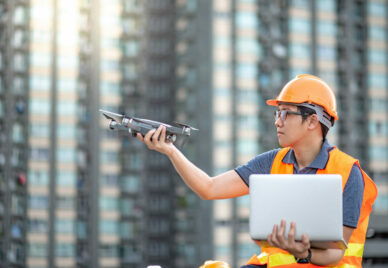 Asian engineer man using drone and laptop for site survey