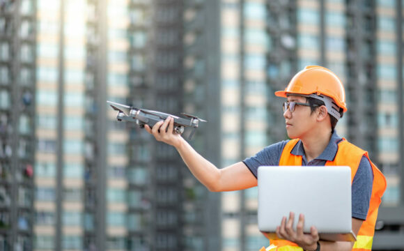 Asian engineer man using drone and laptop for site survey