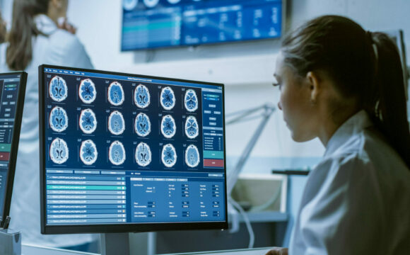 Female Medical Research Scientist Working with Brain Scans on He