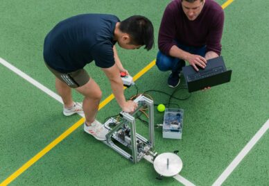 Two engineers are testing a robot