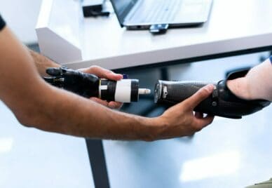 An engineer is setting up an artificial arm