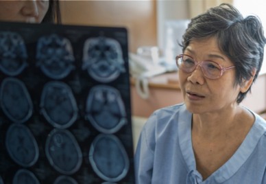 An elderly woman being shown images of her brain