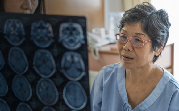 An elderly woman being shown images of her brain