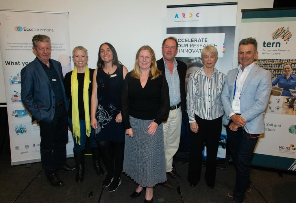 At the EcoCommons Australia launch (L-R): Professor Brendan Mackey, Associate Professor Linda Beaumont, Dr Elisa Bayraktarov, Rosie Hicks, Professor Hugh Possingham, Dr Robyn Cleland and Dr Andre Zerger. Background includes EcoCommons, ARDC and TERN banners.