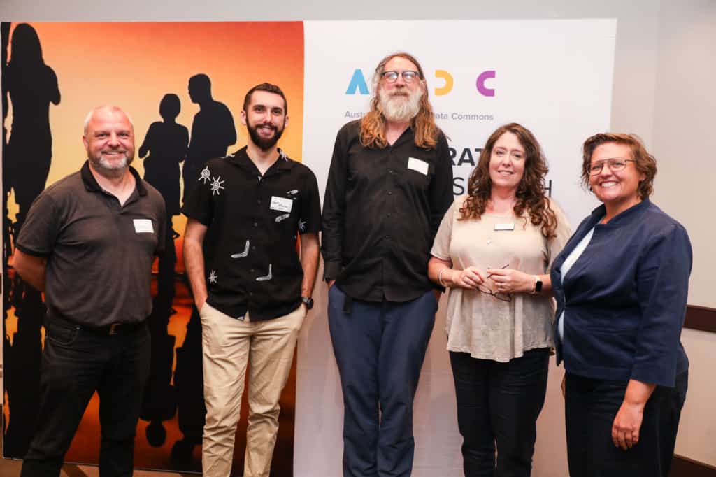 A R D C's Jenny Fewster with attendees in front of the A R D C brand backdrop