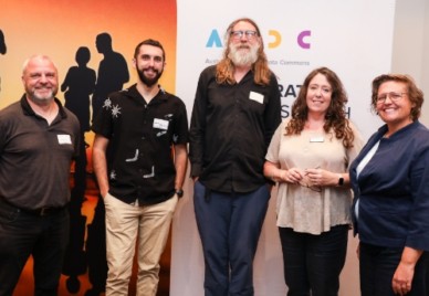5 presenters at the Summer School stand in front of an ARDC banner