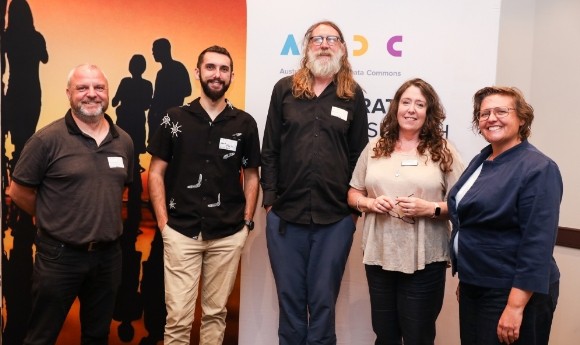 5 presenters at the Summer School stand in front of an ARDC banner