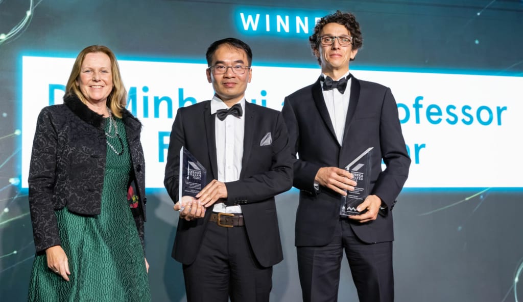 Rosie Hicks, Minh Bui and Robert Lanfear stand on stage at the 2023 Eureka Prizes.