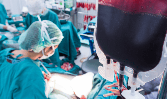 bag of blood being used in an operating theatre in a hospital