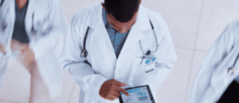 a doctor photographed from above using a tablet