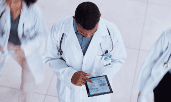 a doctor photographed from above using a tablet