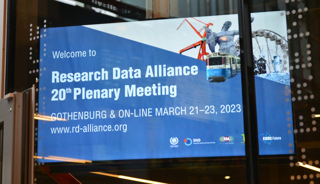 A large screen says " Welcome to Research Data Alliance 20th Plenary Meeting, Gothenburg and Online, March 21-23, 2023'