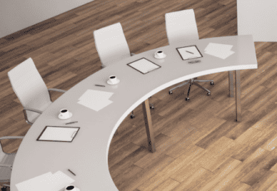 An arc shaped table with chairs and notes and several cups of coffee on it