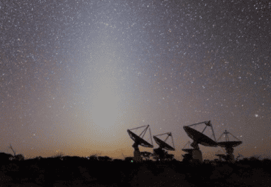 Four telescopes from afar against the night sky
