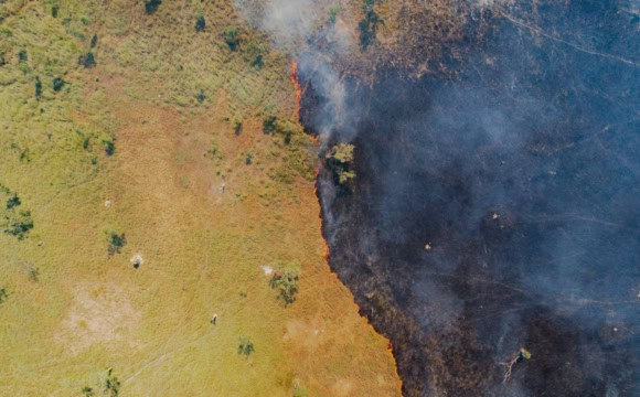 Aerial photo of a bushfire spreading into a grassland