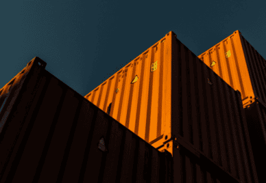 Orange ship containers against blue skies